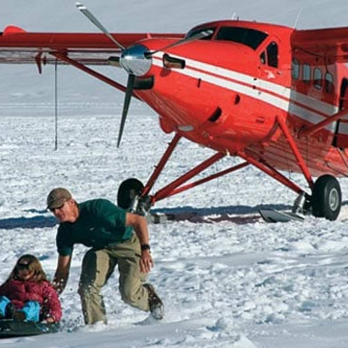 a small plane sitting on top of a snow covered field