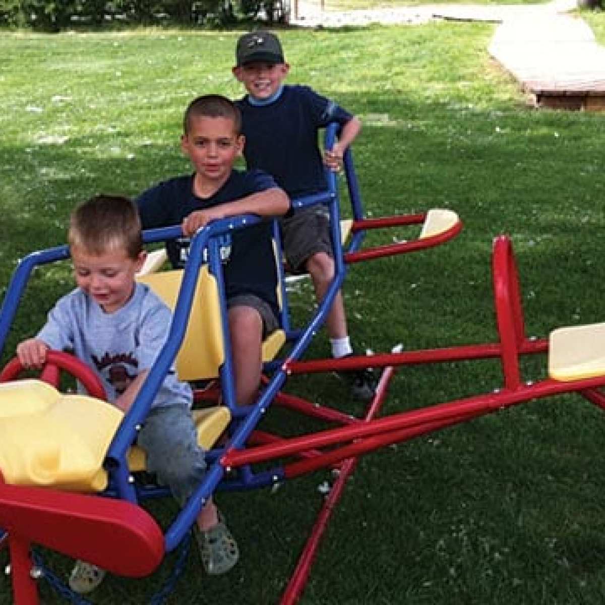 a little boy playing with a toy in a park