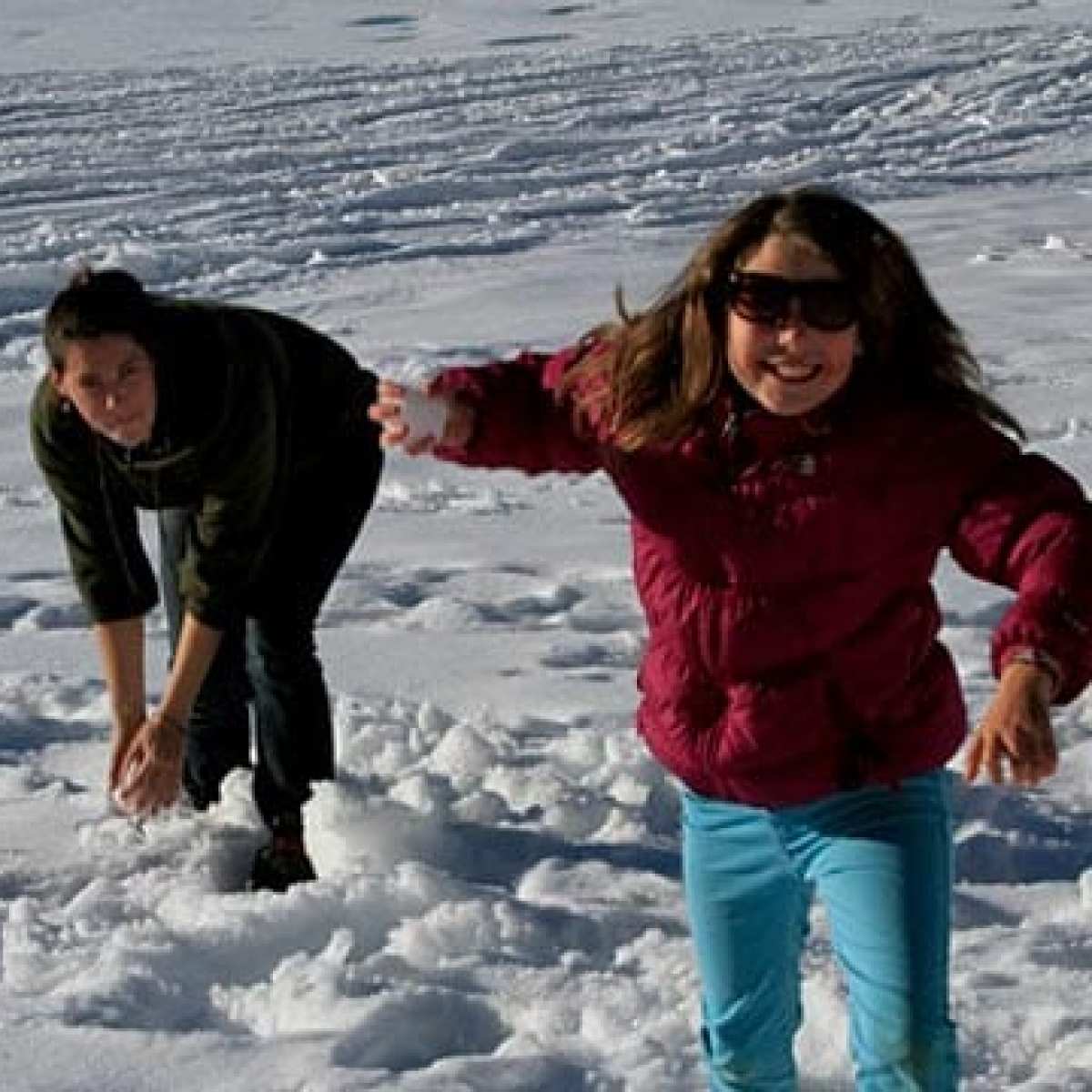 a couple of people that are standing in the snow