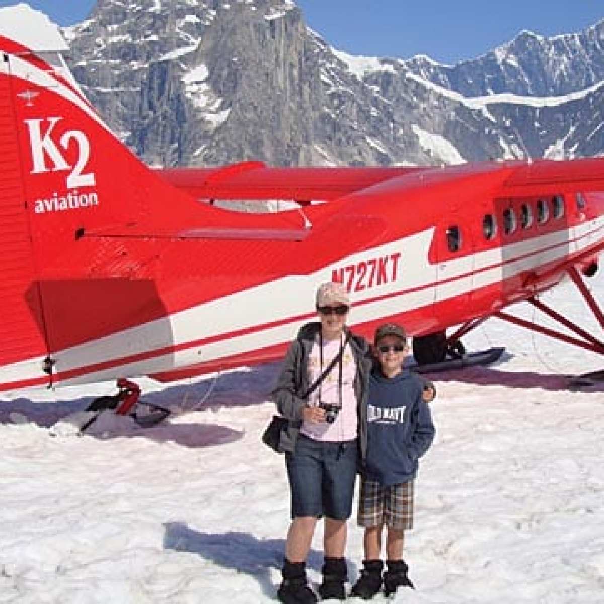 a plane sitting on top of a snow covered mountain