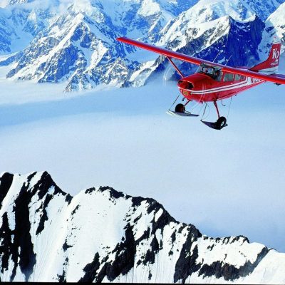 a man riding skis down a snow covered mountain