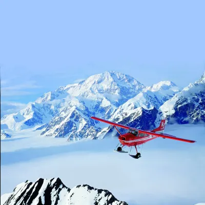 a man riding skis down a snow covered mountain
