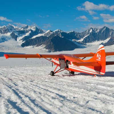 a small plane parked on snow