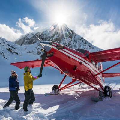 a group of people standing on top of a snow covered mountain