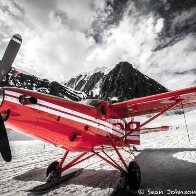 a small plane sitting on top of a snow covered mountain