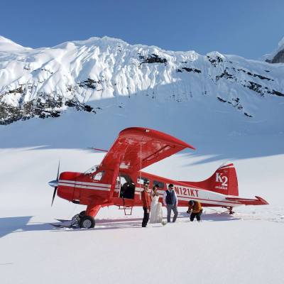 a group of people riding skis on top of a snow covered mountain
