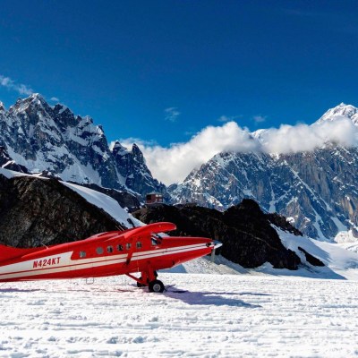 a man riding skis down a snow covered mountain