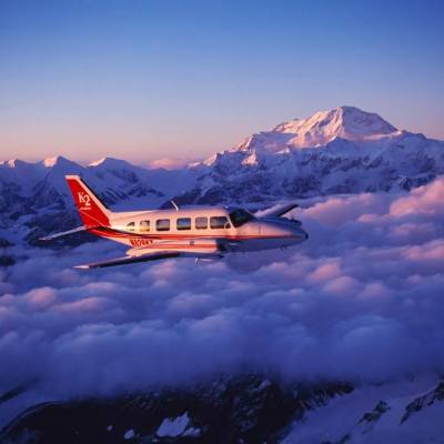 a plane flying over a snow covered mountain