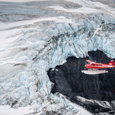 a man riding a snowboard down a snow covered mountain