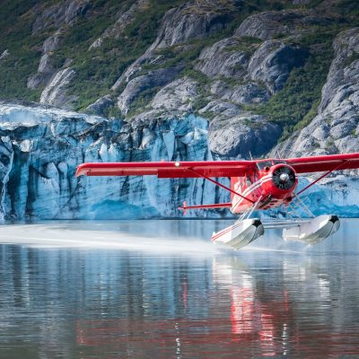 a small boat in a body of water with a mountain in the background