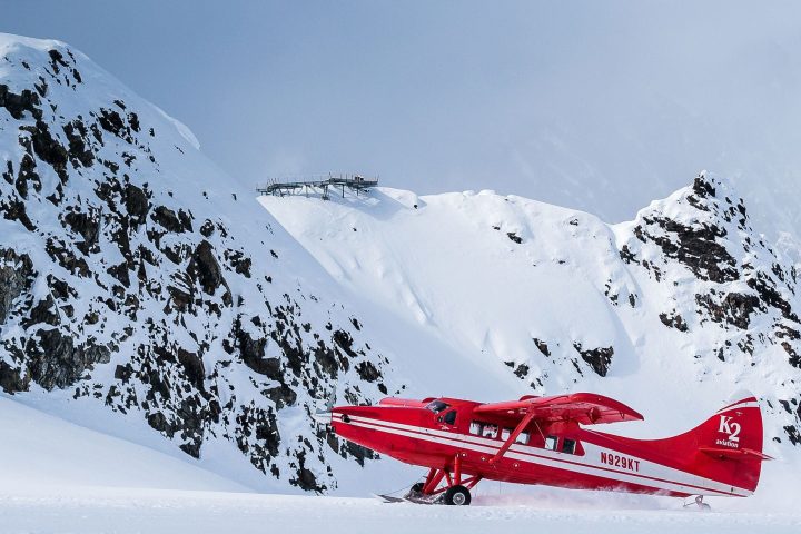 a man riding skis down a snow covered mountain