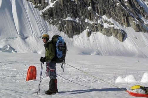 a person riding skis down a snow covered slope