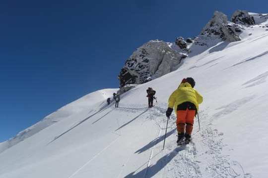 a man riding skis down a snow covered slope