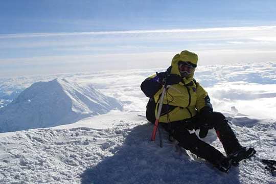 a man riding a snowboard down a snow covered mountain