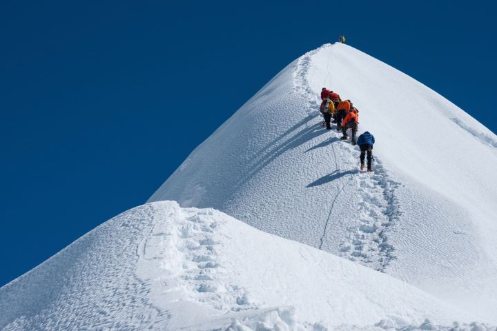 a man jumping in the air on a snow covered slope