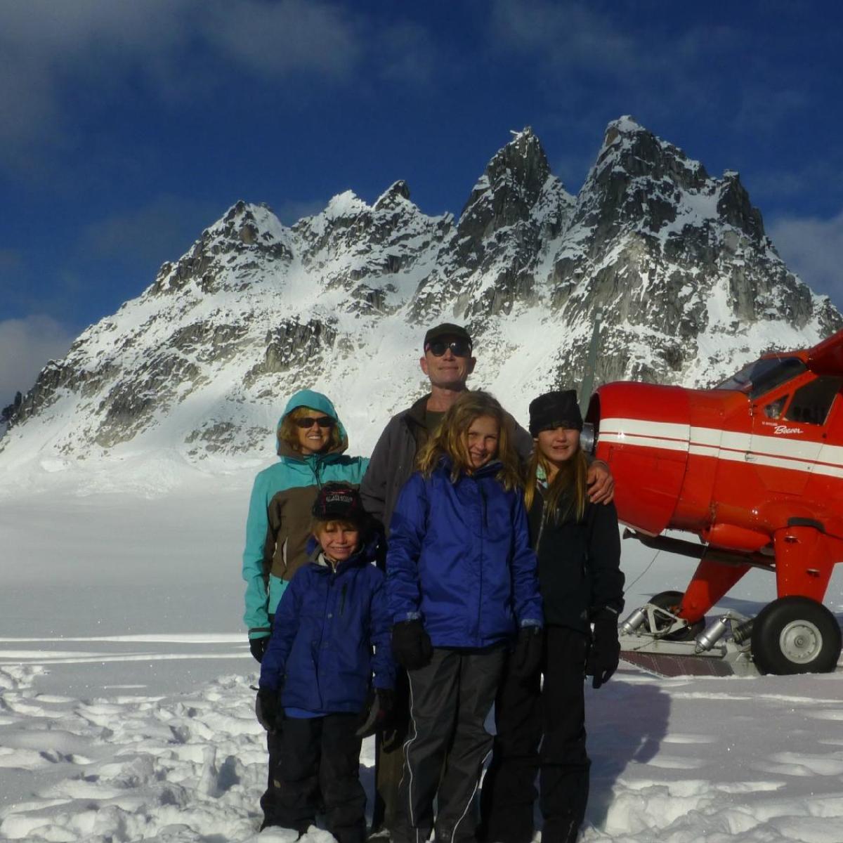 a man standing on top of a snow covered mountain