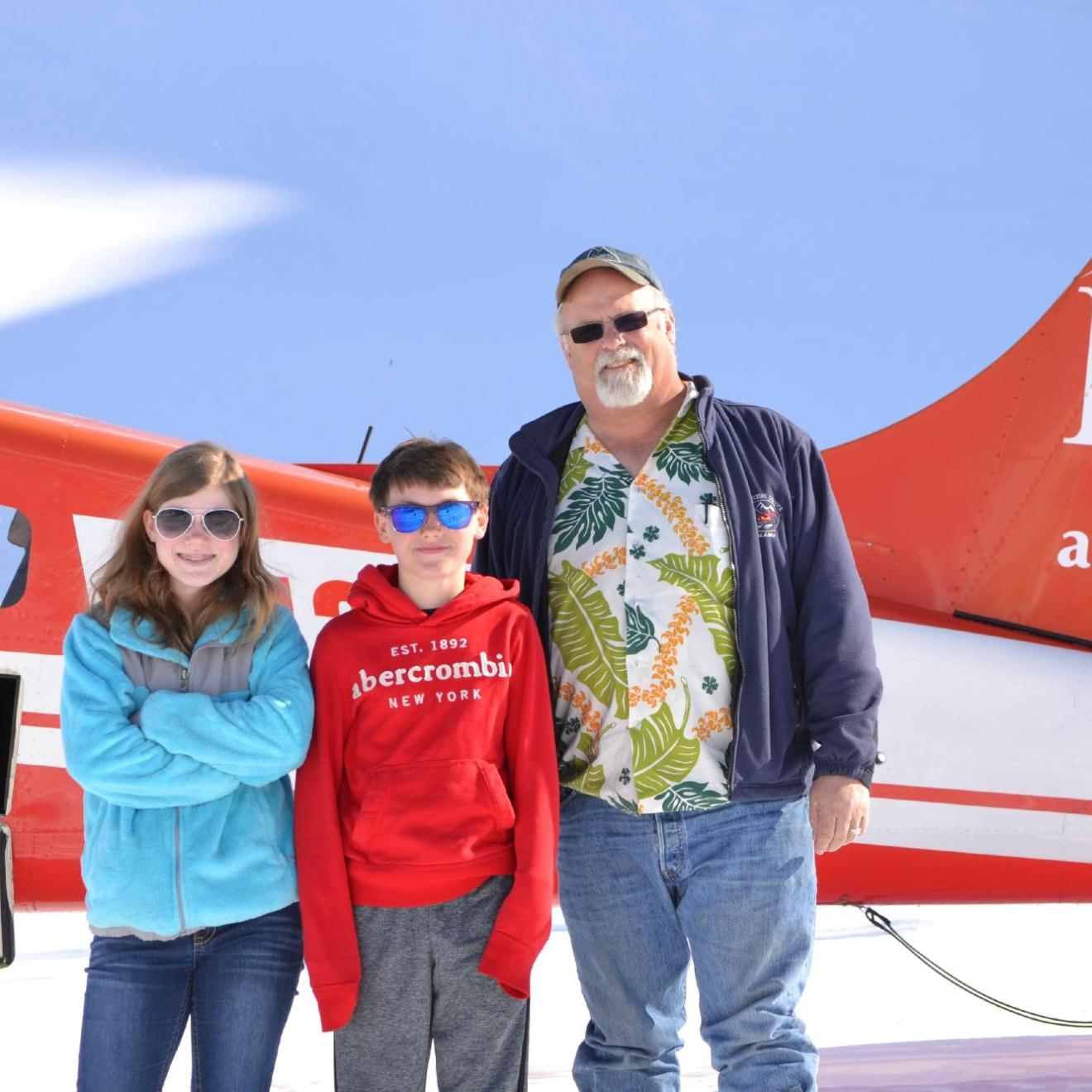 a person holding a sign posing for the camera