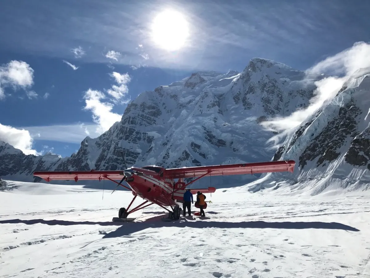 a group of people riding skis on top of a snow covered mountain