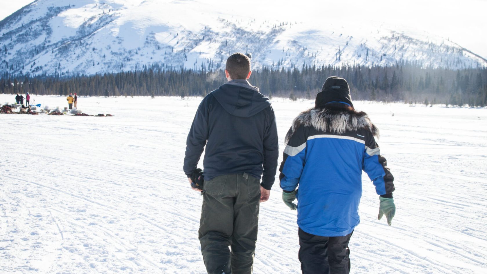 a group of people standing on top of a snow covered slope