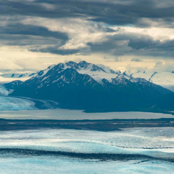 a body of water with a mountain in the background